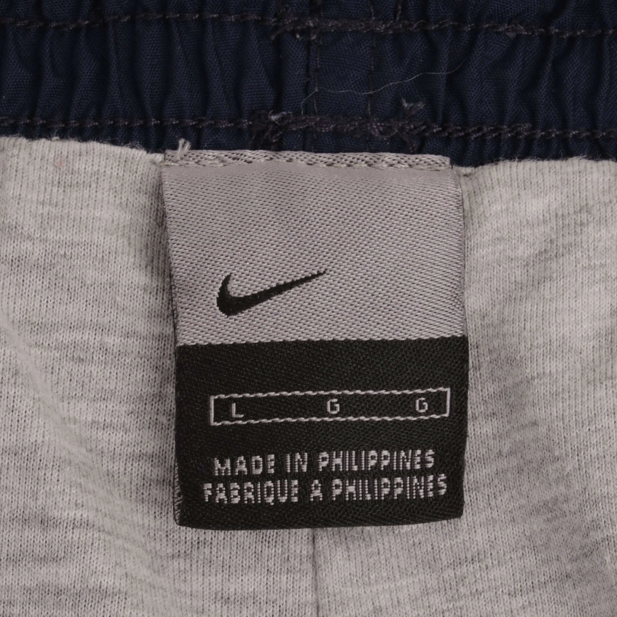 VINTAGE NIKE WHITE AND BLUE NYLON TRACK PANTS 2000S SIZE LARGE